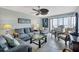 Cozy living room offering comfortable sofa, glass table, tile floor and sliding doors at 14459 River Beach Dr # 129, Port Charlotte, FL 33953