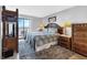 Main bedroom with water view, balcony access, and decorative coastal furnishings at 14459 River Beach Dr # 129, Port Charlotte, FL 33953