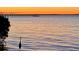 Scenic waterfront featuring a heron in the foreground and a distant pier and colorful sky at 14459 River Beach Dr # 129, Port Charlotte, FL 33953