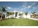 Beautiful home with well-manicured lawn, driveway, and tropical palm trees at 15342 Aron, Port Charlotte, FL 33981
