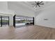 Open living space with tile floors, sliding doors leading to a pool, and coffered ceilings with modern lighting at 15342 Aron, Port Charlotte, FL 33981