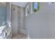 Elegant shower featuring stylish tile accents, a corner seat, and natural light from transom windows at 15342 Aron, Port Charlotte, FL 33981