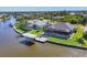 An aerial view of waterfront properties with docks and backyard pools at 15498 Seafoam Cir, Port Charlotte, FL 33981