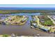 An aerial view of a waterfront community with boat canals and luxurious homes at 15498 Seafoam Cir, Port Charlotte, FL 33981