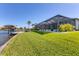 Well-maintained backyard with a screened lanai, lush lawn, and a waterfront view at 15498 Seafoam Cir, Port Charlotte, FL 33981