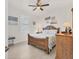 Comfortable bedroom with wooden furniture, a shuttered window, and neutral decor at 15498 Seafoam Cir, Port Charlotte, FL 33981