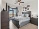 This cozy bedroom features a ceiling fan, ensuite bathroom, and waterfront view at 15498 Seafoam Cir, Port Charlotte, FL 33981