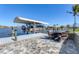 Dock with a covered boat lift and seating area, perfect for enjoying waterfront living at 15498 Seafoam Cir, Port Charlotte, FL 33981