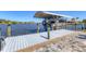 Dock with a covered boat lift, providing easy access to the water and boating activities at 15498 Seafoam Cir, Port Charlotte, FL 33981