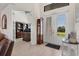 Inviting foyer with tile flooring, a grandfather clock, and double doors leading to the outside at 15498 Seafoam Cir, Port Charlotte, FL 33981