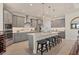 Stylish kitchen with gray cabinets, stainless steel appliances, and a spacious center island with seating at 15498 Seafoam Cir, Port Charlotte, FL 33981