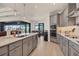 Gourmet kitchen featuring stainless appliances, granite countertops, and an island with seating for four at 15498 Seafoam Cir, Port Charlotte, FL 33981