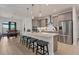 Eat-in kitchen features stainless steel appliances, a spacious island, and seating for four at the breakfast bar at 15498 Seafoam Cir, Port Charlotte, FL 33981