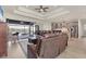Open-concept living room featuring a tray ceiling, modern lighting, and seamless indoor-outdoor flow at 15498 Seafoam Cir, Port Charlotte, FL 33981