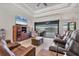 Comfortable living room featuring leather furniture, tile floors, and views of the pool and canal at 15498 Seafoam Cir, Port Charlotte, FL 33981
