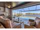 Relaxing outdoor living space with pool, bar, and comfortable seating area overlooking water at 15498 Seafoam Cir, Port Charlotte, FL 33981