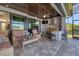 This outdoor space with comfortable seating, an outdoor kitchen, and serene views of the water at 15498 Seafoam Cir, Port Charlotte, FL 33981