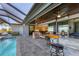 Outdoor space with a pool, kitchen and several doors leading to indoor areas at 15498 Seafoam Cir, Port Charlotte, FL 33981