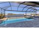 Beautiful pool and water view from a screened-in lanai, perfect for relaxing and entertaining guests at 15498 Seafoam Cir, Port Charlotte, FL 33981