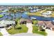 Aerial view of stunning waterfront home with lush landscaping, private dock, and beautiful water views at 15690 Viscount Cir, Port Charlotte, FL 33981