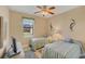 Cozy bedroom with twin beds, a ceiling fan, and a serene atmosphere perfect for rest and relaxation at 15690 Viscount Cir, Port Charlotte, FL 33981
