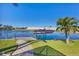 Property includes dock, boat lift, canal access and tropical landscaping at 15690 Viscount Cir, Port Charlotte, FL 33981