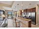 Modern kitchen with granite countertops, stainless appliances, bar-style seating, and water view at 15690 Viscount Cir, Port Charlotte, FL 33981