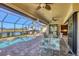 Outdoor lanai with a pool, dining area, ceiling fans and a serene view, perfect for entertaining at 15690 Viscount Cir, Port Charlotte, FL 33981