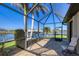 Screened lanai with brick paving and comfortable seating, offering water views at 15690 Viscount Cir, Port Charlotte, FL 33981