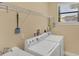 Practical laundry room with modern appliances, storage shelves, and a sink, designed for efficiency at 15690 Viscount Cir, Port Charlotte, FL 33981