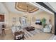 Spacious living room featuring tray ceilings, neutral decor, and a seamless transition to the outdoor entertainment area at 15690 Viscount Cir, Port Charlotte, FL 33981