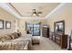 Main bedroom with tray ceilings, water views, and furniture set, designed for relaxation at 15690 Viscount Cir, Port Charlotte, FL 33981