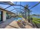 Enclosed pool features brick paving, a dining table and seating area at 15690 Viscount Cir, Port Charlotte, FL 33981