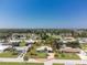 Aerial view of the property surrounded by lush greenery and charming neighborhood at 1680 Meadow Lark Ln, Englewood, FL 34224