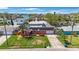 Aerial view of the home showing the front yard, lawn, and water in the background at 1694 Harbor W Cir, Largo, FL 33770