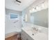 Bright and clean bathroom with a large mirror and a shower with built-in seating at 1694 Harbor W Cir, Largo, FL 33770