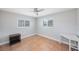 Bright bedroom with a ceiling fan, tile floors, and two windows with white shutters at 1694 Harbor W Cir, Largo, FL 33770