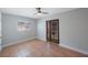 Bright bedroom with a ceiling fan, a window, and a door leading to the outside at 1694 Harbor W Cir, Largo, FL 33770