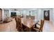 Open dining room with a large wooden table, neutral walls, and terra cotta tile flooring at 1694 Harbor W Cir, Largo, FL 33770