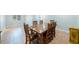 Open dining room with a large wooden table, neutral walls, and terra cotta tile flooring at 1694 Harbor W Cir, Largo, FL 33770