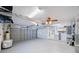 Spacious garage with laundry area, ceiling fan, and storage at 1694 Harbor W Cir, Largo, FL 33770