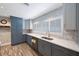 Kitchen featuring stainless steel appliances, white countertops, and gray cabinetry at 1694 Harbor W Cir, Largo, FL 33770