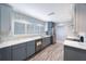 Updated kitchen with stainless appliances, white countertops, and gray cabinetry at 1694 Harbor W Cir, Largo, FL 33770