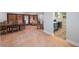 Open-concept living room with terracotta tile flooring, shuttered windows, and an eat-in kitchen at 1694 Harbor W Cir, Largo, FL 33770