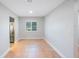 Well-lit living room with white baseboards and neutral colored walls and tile floors at 1694 Harbor W Cir, Largo, FL 33770