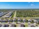 Expansive aerial view showcasing a peaceful neighborhood with serene surroundings and mature trees at 1824 Saddlewood Cir, Port Charlotte, FL 33953