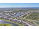 Aerial view of the community and surrounding area with a network of lakes and green spaces at 1824 Saddlewood Cir, Port Charlotte, FL 33953