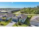 Aerial view of a well-maintained home in a quiet community, featuring lush landscaping and a paved driveway at 1824 Saddlewood Cir, Port Charlotte, FL 33953
