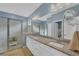 Bright bathroom features dual sinks, granite countertops, and a tiled walk-in shower with glass doors at 1824 Saddlewood Cir, Port Charlotte, FL 33953