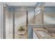 Modern bathroom featuring a tiled walk-in shower with glass doors and a granite countertop vanity at 1824 Saddlewood Cir, Port Charlotte, FL 33953